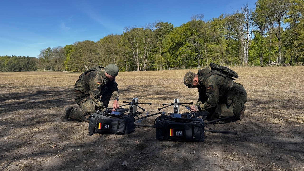 Two soldiers prepare Vectorbirds UAV systems for a mobile field mission.